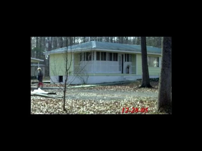 Original picture shows the front window of the house and the man standing in it.