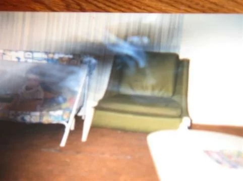 The black and white ghost mist begins to form a person, possibly, Kathy's grandmother.