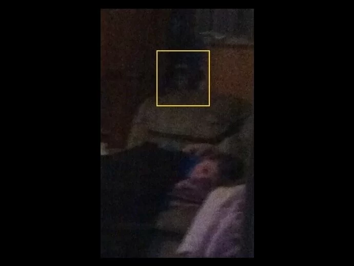 Could this be the photograph of a ghostly figure behind the couch?