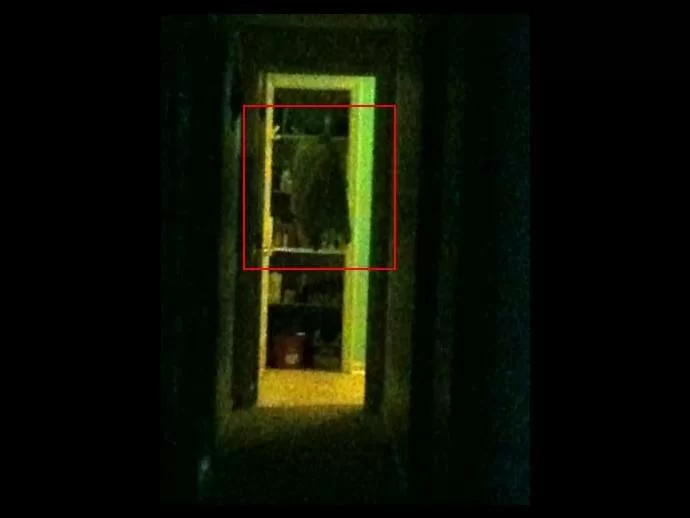 Original ghost picture taken with a smart phone camera, looking down the hallway. We boxed the coat in red.