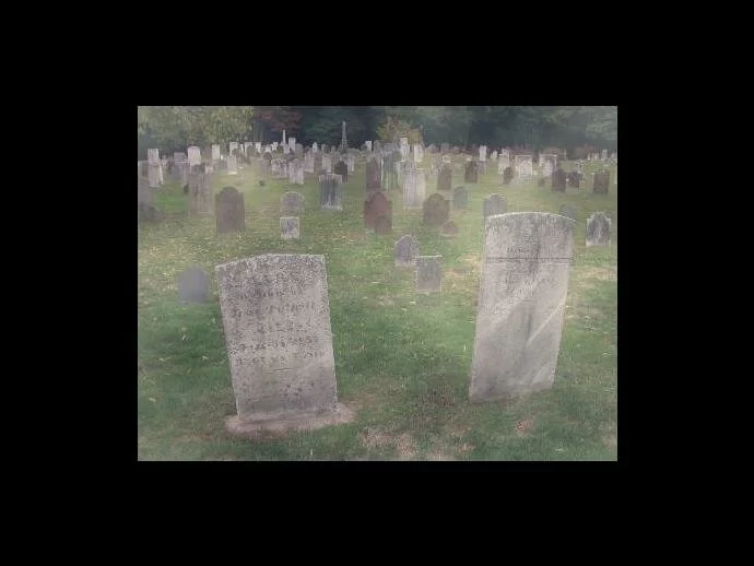 An apparition is in front of some headstones. Is it real?