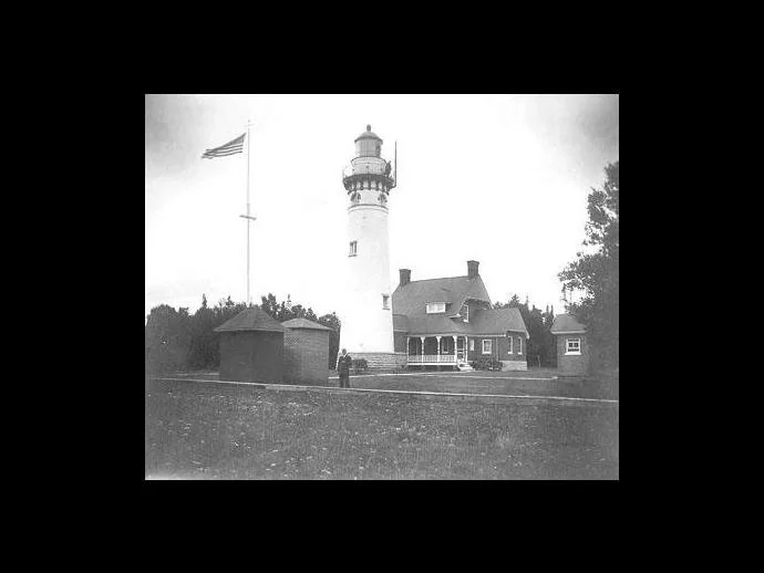 The Seul Choix Lighthouse in an old photo with its keeper of that day
