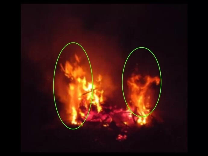 Two figures to the right, an angel looking being to the left in this fire. Image from Marie Ann B. Rey.