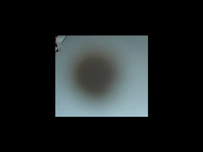 Created with a spot of white liquid on the lens. The opacity of the liquid caused the orb to appear dark shadowed
