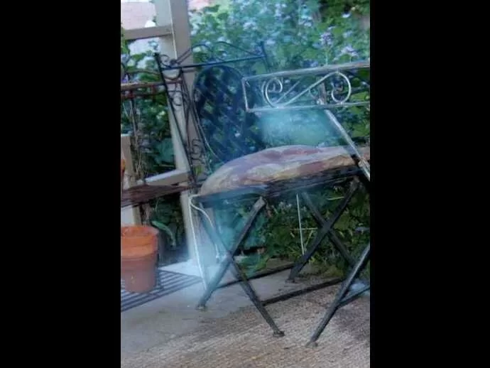 Is a person sitting in the chair, the mist taking a form of a person, possibly?
