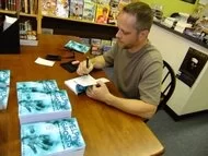 Louis Charles signing copies of Helping Ghosts
